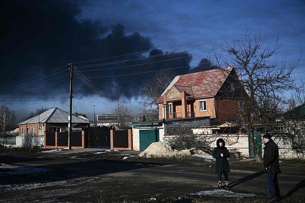 The smoke in the background is from a Russian attack on a Ukrainian airport, 24 February 2022. (Aris Messinis / AFP)